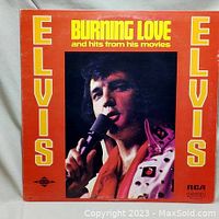 Front cover of the vinyl album showing Elvis Presley in a red jacket singing into a microphone with yellow text.