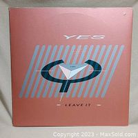 Front cover of the vinyl single "Leave It" by Yes, showing the band's logo and title in peach and blue.