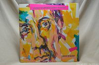 Front cover of Pete Townshend Scoop double album with abstract colorful face artwork.