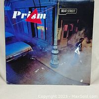 Front cover of Prism Beat Street vinyl LP showing street corner scene and album title.