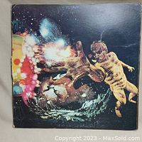 Photo of the outer gatefold cover showing psychedelic artwork with abstract colorful main figure and child figure.