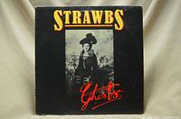 Front cover of Strawbs Ghosts vinyl LP album showing title and artwork featuring a woman in vintage attire.