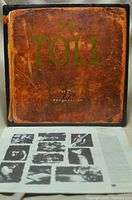 Front cover of The Toll 'The Price of Progression' vinyl record album showing worn brown cover with the band name and album title.