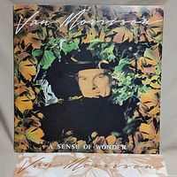Front cover of the Van Morrison 'A Sense of Wonder' vinyl album showing album artwork with Van Morrison's image and foliage.