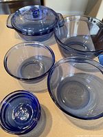 Cobalt blue glass bowls including covered serving bowl and mixing bowls.