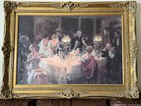 Wide shot of the framed formal dinner party picture showing full view with ornate gold frame.