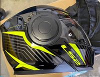 Side view of the LS2 motorcycle helmet showing yellow and grey design