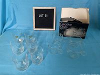 Four clear glass mugs with handles, textured design, shown with original Creative Glass by Corning packaging.