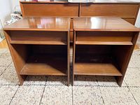 Front view of two wooden night stands showing open shelf and bottom compartment.