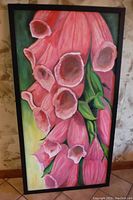 Photo of the painting showing pink bell flowers in a black wooden frame, set against a mottled stone wall background.