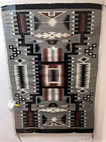 Full view of Navajo rug behind plexiglass panel