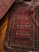 Full view of the Afghan Turkmen Ersari wool rug, rust-red field with central gul rows and wide border.