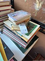 Stack of various art books on European art, some hardcover, some softcover, visible titles include orientation and artist names