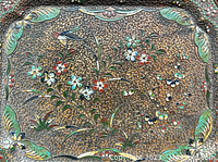 Close-up of the top of the tray showing detailed cloisonne enamel with colorful floral and bird design and scalloped edge.