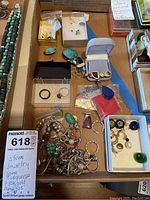 Overhead view of lot: turquoise bead necklace at top left, assorted boxes with rings, earrings, pendants, pile of bracelets and loose jewelry at bottom left