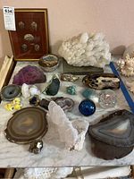 Overall view of 23 piece rock and mineral collection on marble surface
