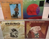 Four sealed LP albums arranged side by side: Milt Matthews Inc. front cover showing the artist in hat and patterned shirt, Django Django Hi Djinx! geometric colorful artwork with circular shapes, Rob Galbraith Nashville Dirt with sepia tone image of the artist, Ken Dunn Ashes in the Morning with portrait of elderly person on warm toned background.