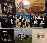 Nine front-cover LPs including Alice Cooper, Queen, Beatles, Rolling Stones, Kiss, Pink Floyd, Deep Purple