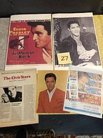 View of Jailhouse Rock poster, various Elvis Presley photos, Circus magazine article, and mini posters spread on a surface showing condition and lot content.