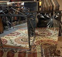 Metal framed mirror with decorative scroll design and etched flower design on adjacent beveled glass mirror, showing size and condition.