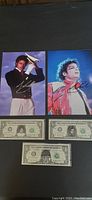 Two signed Michael Jackson photos above three collectible dollar bills