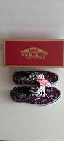 Photo showing the Vans shoe box and pair of shoes with floral and polka dot pattern