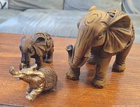 Front view of the three elephant figurines showing size comparison and detail