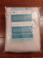 Photo of packaged Martha Stewart fleece blanket with label showing product details and branding.