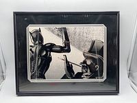 Front view of the framed print showing Catwoman and Penguin characters in black and white style.