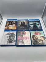Front side of 6 Blu-ray cases arranged in two rows showing cover art for movies Pirates of Somalia, Tiger House, The Shadow Effect, Distorted, War Dogs, and Fist Fight.