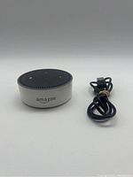 Amazon Echo 2 smart speaker front and power cable showing device top with Alexa control buttons.