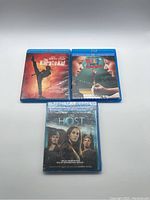 Front view of all three Blu Ray movie cases: The Karate Kid, Help I Shrunk the Teacher, and The Host.