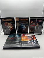 Front view of 5 horror genre DVDs showing their covers including Halloween, Halloween collection, Nightmare on Elm Street double feature, and Friday the 13th double feature.