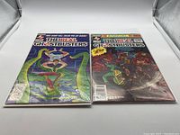 Two copies of The Real Ghostbusters comic book, issue 14, standing upright side by side showing cover art featuring characters in ghost/monster scenarios.