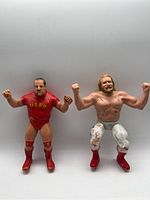 Front view of two vintage WWF wrestler action figures Big John Studd and The Russian showing detailed outfits and poses
