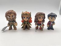 All four DC Kids Funko Figures together with Aquaman, Mera, Wonder Woman and a boy character