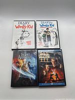 Front view of all 4 DVD cases showing cover artwork for Diary of a Wimpy Kid, Diary of a Wimpy Kid Rodrick Rules, The Last Airbender, and Star Wars Episode III Revenge of the Sith.