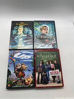 Front covers of the 4 family movie DVDs - The NeverEnding Story, The Pagemaster, Disney's Up, The Breakfast Club.