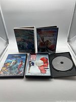 Front view of five DVD cases and one disc-only DVD (Wreck-It Ralph) showing cover art of the animated movies in the lot.