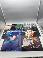 Overview of all six Game Informer magazines with varied covers representing different video games.