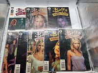 Eight Buffy the Vampire Slayer comic books visible in protective sleeves, showing front covers with photographic style images of Buffy and other characters.