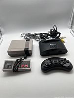 Both retro mini gaming consoles with wired controllers and AV cables laid out, showing front and top sides.