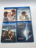 Front view of four Blu-ray cases: The Longest Ride, Safe Haven, The Host, and Gravity.