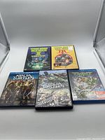Front side of 5 Teenage Mutant Ninja Turtles movies including DVDs and Blu-rays with various covers.