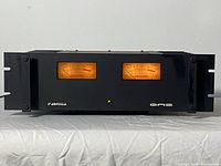 Front view showing dual VU meters, green LED indicator, Ampzilla and Gas logos