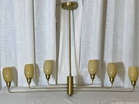 Full front view of six-arm chandelier with shades