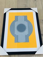 Frontal view of framed abstract print showing full composition and frame with protective corners