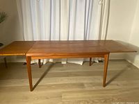 Table fully extended showing two leaves pulled out and overall profile