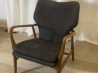 Front three-quarter view showing wood frame, seat and back cushions