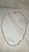 Full view of the antique moonstone bead necklace laid out flat.